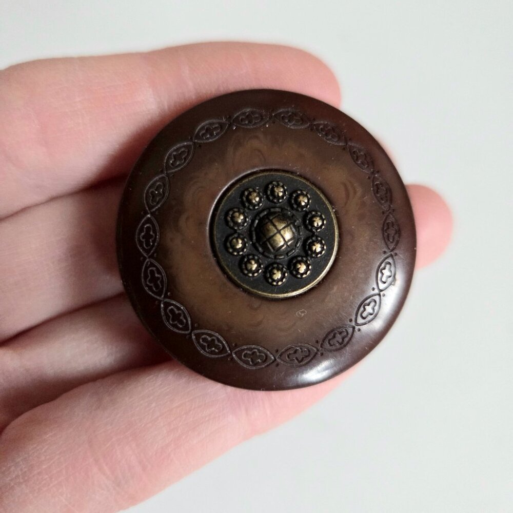 Vintage Bakelite round brown brooch with metal details.